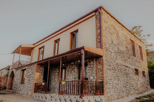 a brick building with a balcony on the side of it at Telavi Tel Aviv in Tʼelavi