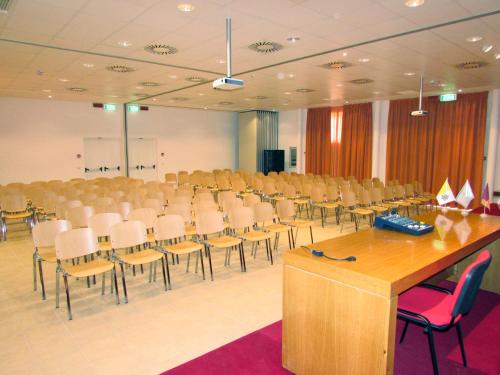 a large room with rows of chairs and tables at Casa per Ferie Opera Don Calabria in Rome