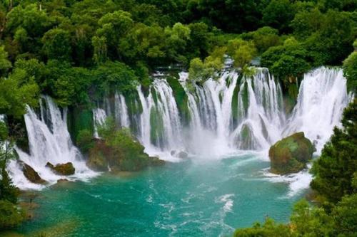 a waterfall in the middle of a river at Ferienhaus in Široki Brijeg