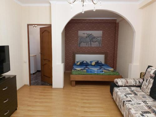 a living room with a bed and a couch at Двухкомнатная квартира в Пицунде in Pizunda