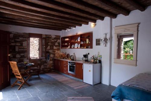 cocina con armarios de madera y mesa en Valeondades en Valeontádes