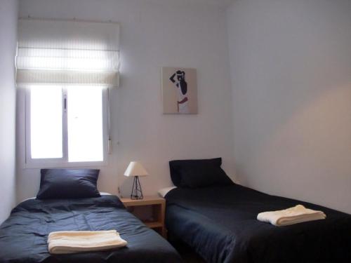 two beds sitting next to each other in a bedroom at Ayamonte Mirador in Ayamonte