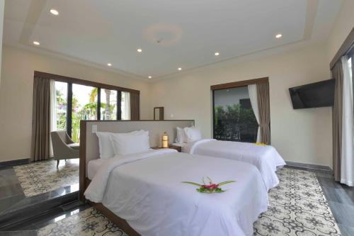 Tempat tidur dalam kamar di Cocoland River Beach Resort & Spa