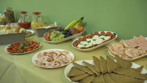 a table with many plates of food on it at Naxos Laguna Beach in Giardini Naxos