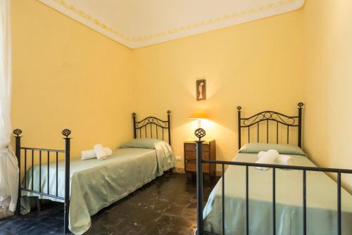 Ένα ή περισσότερα κρεβάτια σε δωμάτιο στο Villa Zottopera - Dimora di Sicilia