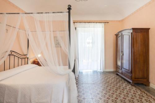 Ένα ή περισσότερα κρεβάτια σε δωμάτιο στο Villa Zottopera - Dimora di Sicilia