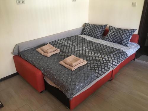 a bed with two pillows on top of it at Sofia Family House - Free Parking in Sofia