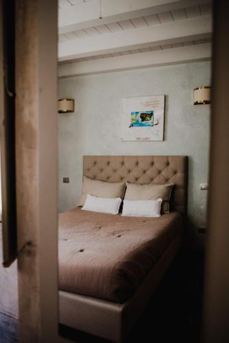 a bedroom with a large bed with two pillows at Regina Teodolinda Suites in Laglio