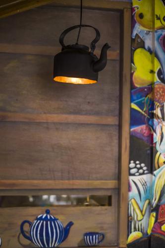 a black lamp hanging from a wooden cabinet at By the shade Maldives in Hangnaameedhoo