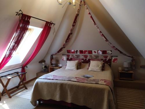 a bedroom with a large bed in a attic at DUCK HOUSE in Saint-Wandrille-Rançon