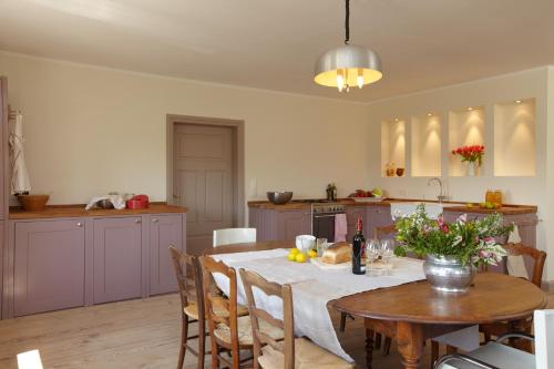 a kitchen with a table and a dining room at Gutshaus Lexow in Lexow