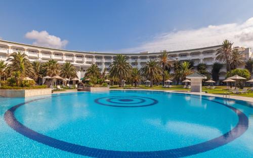 a large swimming pool in front of a large building at OCEANA Hotel & Spa in Hammamet