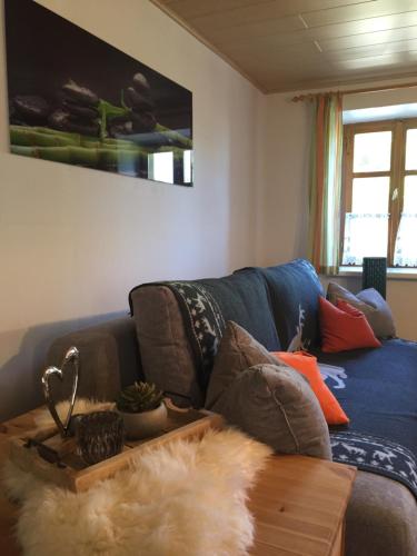 a living room with a blue couch and a table at Ferienhaus Perwolff in Eisenberg an der Pinka