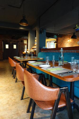 a row of tables and chairs in a restaurant at Araiya Palampur in Pālampur