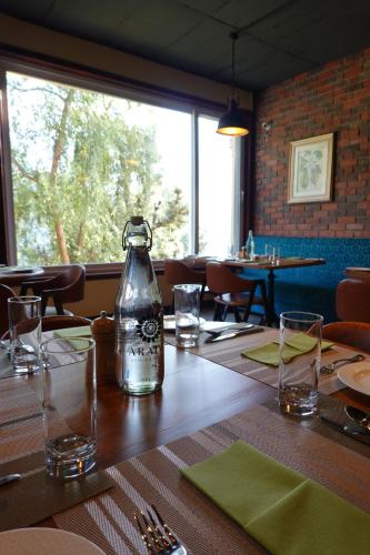 a bottle of water sitting on a table in a restaurant at Araiya Palampur in Pālampur