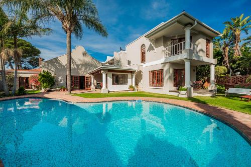 a large swimming pool in front of a house at Millbury Guest House in Port Elizabeth