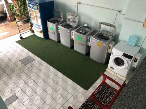 a row of trash cans lined up in a room at Krissana Mansion in Hat Yai