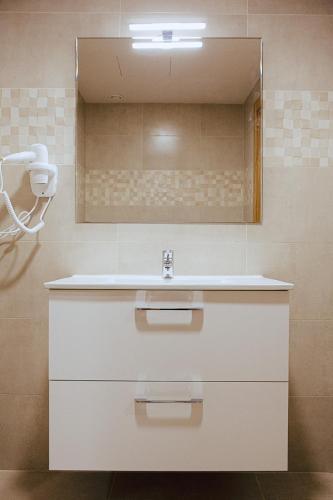 a bathroom with a sink and a mirror at Apartamentos Ducay in Olite