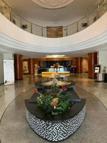 a lobby with a fountain in the middle of a building at Executives Hotel - Olaya in Riyadh