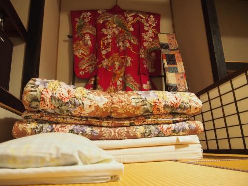 a stack of blankets sitting on top of a table at Kakure-Yado Yuji-inn in Kurashiki