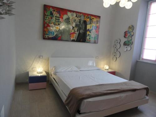 a bedroom with a bed and a painting on the wall at Sapore di mare in Sestri Levante
