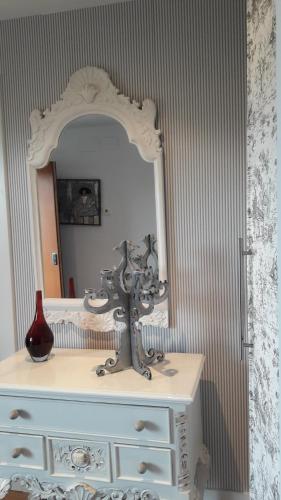a white dresser with a mirror on top of it at Bakio Ocean View in Bakio