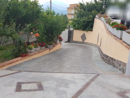 a walkway with potted plants on the side of a building at Villa S.Antonio in Ascea