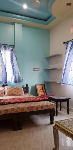 a bedroom with a large bed and a table at Jagat Villa Guest House in Udaipur