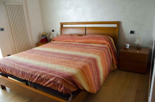 a bedroom with a bed and two night stands at Villetta Glicine in Brentonico