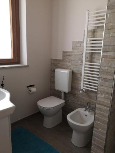 a bathroom with a toilet and a sink at Slowliday in Viverone