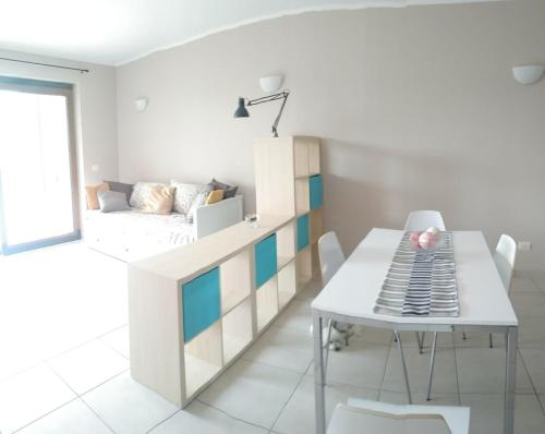 a room with a bed and a table and chairs at Slowliday in Viverone