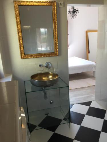 a bathroom with a sink and a mirror on the wall at Villa Marija in Vrsar