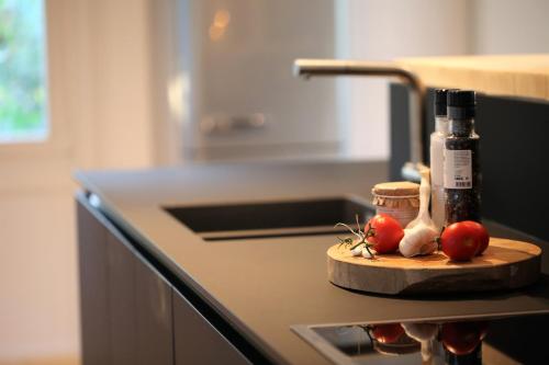 a kitchen counter with a cutting board with tomatoes on it at N8Quartier Chalet in Bad Münstereifel