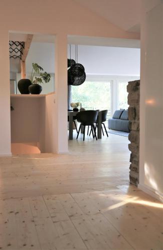 a living room with a wooden floor and a dining room at N8Quartier Chalet in Bad Münstereifel