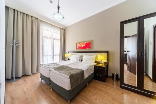 a bedroom with a large bed and a large window at Apartments in Gorki Gorod in Estosadok