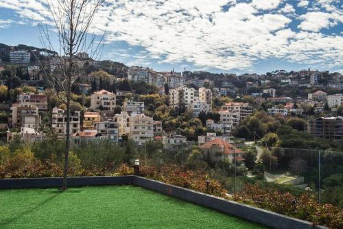 a view of a city from the roof of a house at Le Pave Hotel in Bayt al Kūkū