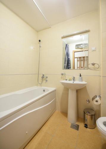 a bathroom with a tub and a sink and a toilet at Enigma in Podgorica