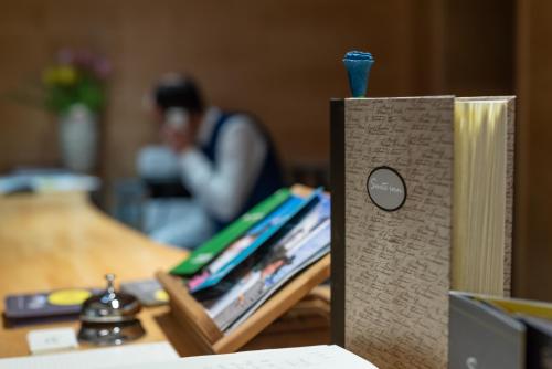 a book sitting on a table next to a table with a book at Hotel Suite Inn in Udine