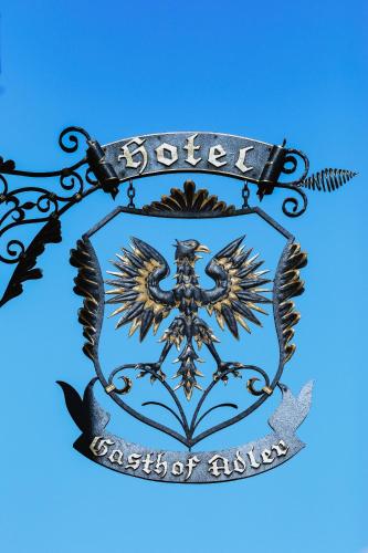 a metal sign with a coat of arms on a blue background at Hotel & Restaurant Adler in Hornberg