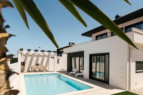 a villa with a swimming pool and a house at Obidos House with private pool in Bairro
