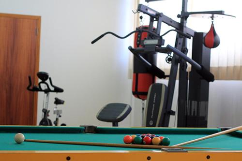 a room with a pool table and a gym at Castelo Palace Hotel in Batatais