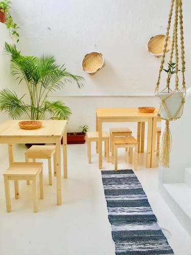 a dining room with wooden tables and a rug at Casa Sodadi in Praia