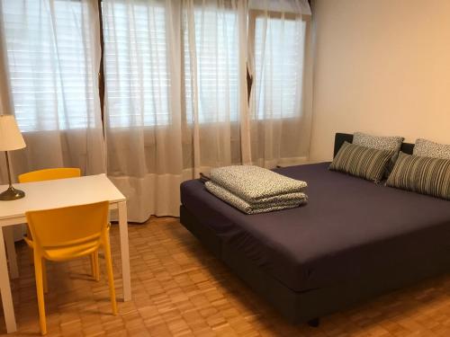 1 dormitorio con cama, mesa y escritorio en Apartment 33A - No Bikes - Self check-in, en Lugano