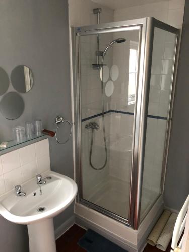 a bathroom with a shower and a sink at Channel View Guest House in Stoke Fleming