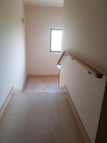 an empty room with stairs and a window at "La casa di Mariagrazia" Appartamento 4 locali in Sammichele di Bari