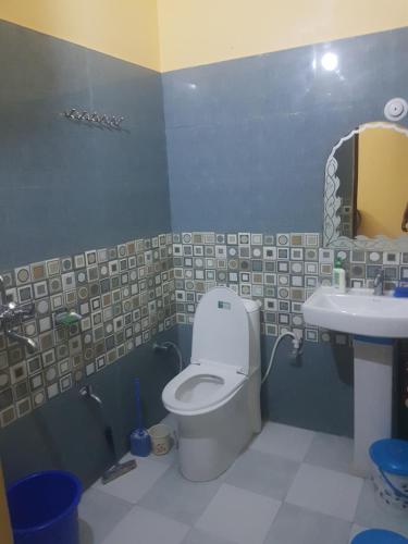 a bathroom with a toilet and a sink at SM Guest House in Lucknow