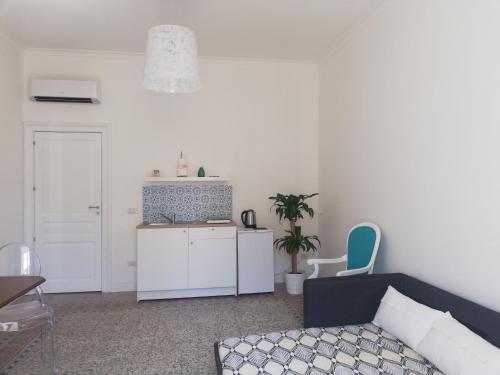 a living room with a couch and a table at D-Home Ortigia in Siracusa