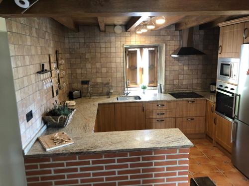 a kitchen with a sink and a counter top at Las vistas in Cornellana