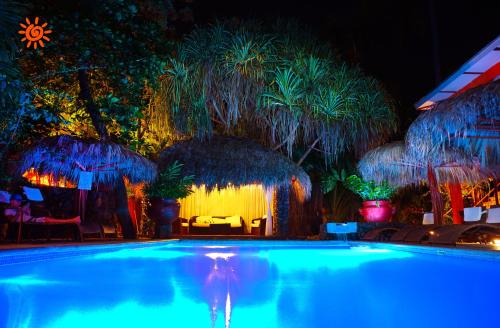 a swimming pool at a resort at night at Locanda Samara Beach in Sámara