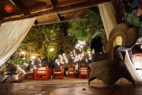 a patio with a bunch of lights and chairs at Locanda Samara Beach in Sámara